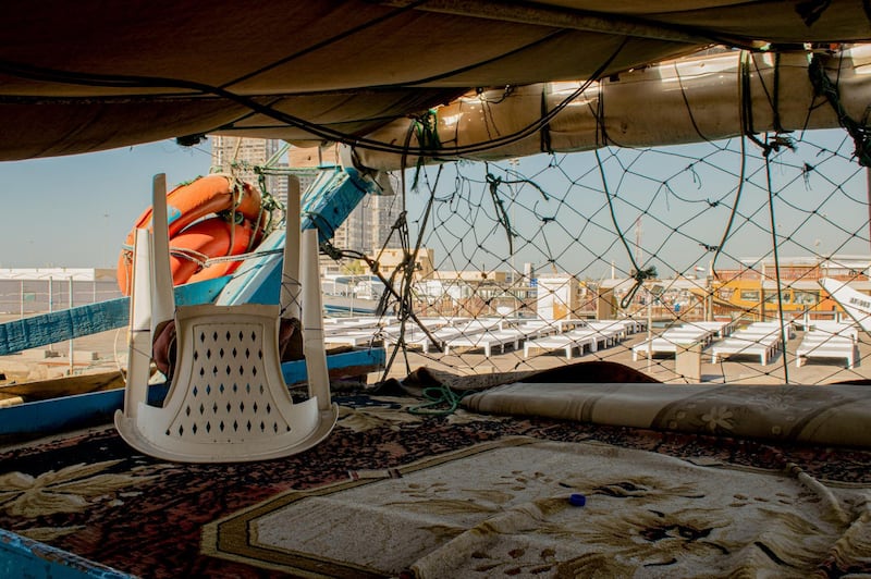 Hundreds of fishermen in Abu Dhabi's Mina Ziyad have returned home after restrictions on fishing have made it hard to make a living. Each boat in the port is occupied by four to five men who would come up to the decks to rest
