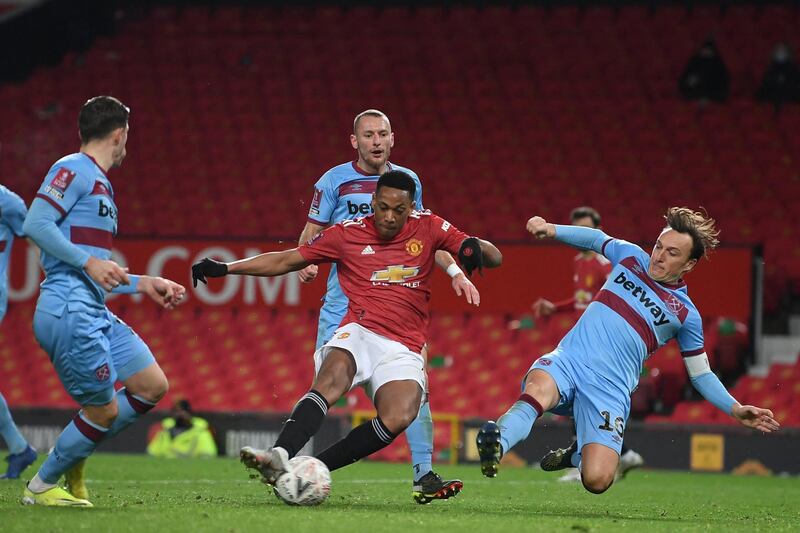 Manchester United's French striker Anthony Martial (C) misses a chance at goal during the English FA Cup fifth round football match between Manchester United and West Ham United at Old Trafford in Manchester, north west England, on February 9, 2021. (Photo by Michael Regan / POOL / AFP) / RESTRICTED TO EDITORIAL USE. No use with unauthorized audio, video, data, fixture lists, club/league logos or 'live' services. Online in-match use limited to 120 images. An additional 40 images may be used in extra time. No video emulation. Social media in-match use limited to 120 images. An additional 40 images may be used in extra time. No use in betting publications, games or single club/league/player publications. / 