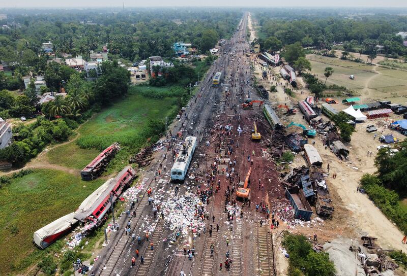 A drone view shows diggers removing damaged coaches following the train collision. Reuters