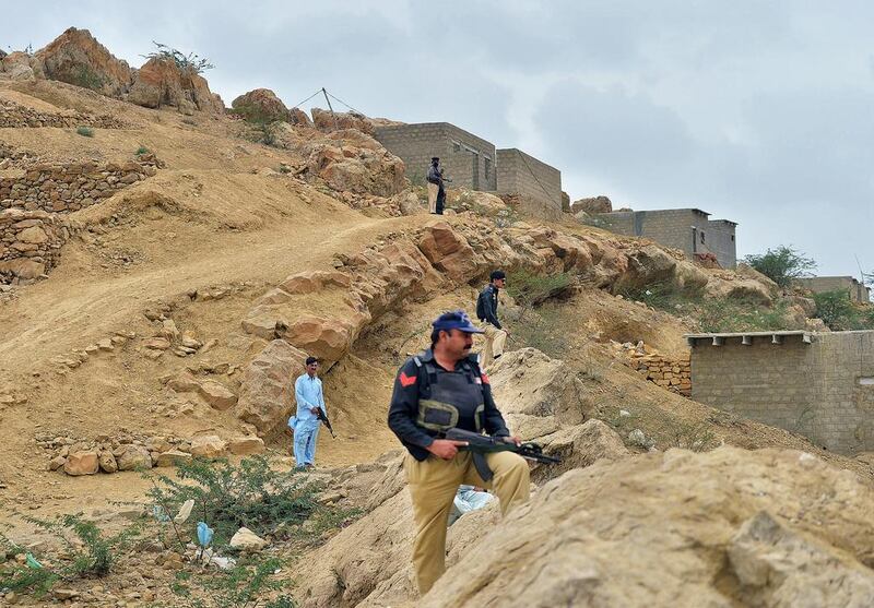 Pakistani police patrol destroyed Taliban hideouts in west Karachi. Rizwan Tabassum / AFP