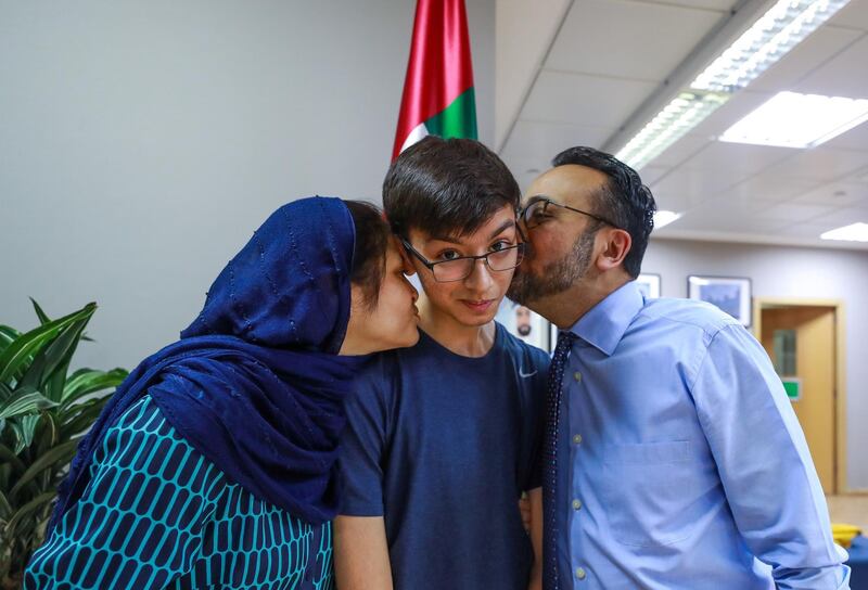 Abu Dhabi, U.A.E., August 16 , 2018. Pupils receiving their A level results at Al Yasmina Academy.  Proud mother and father, Nadir and Sameen Jafarey give their son, Zaid a kiss.
Victor Besa / The National
Section:  NA
Reporter:  Anam Rizvi