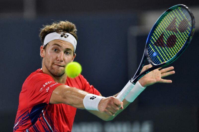 Casper Ruud plays a volley to Stefanos Tsitsipas. AFP