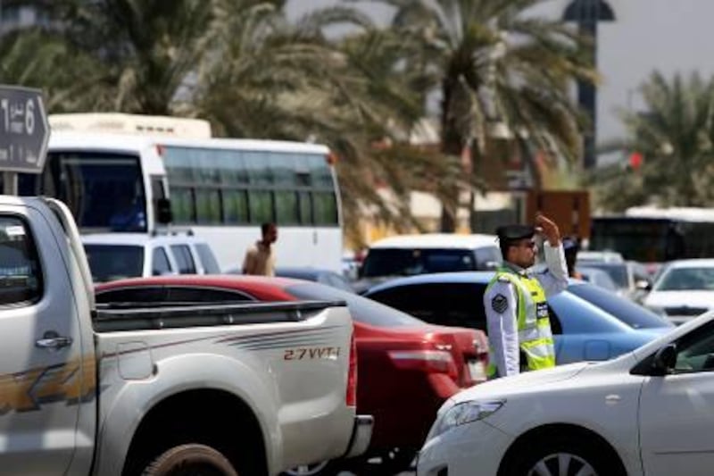 September 26, 2010 / Abu Dhabi / (Rich-Joseph Facun / The National)  A police officer directs traffic at the intersection of Al Saada Street and Al Falah Street heading into the Tourist Club area, Sunday, September 26, 2010 in Abu Dhabi. 