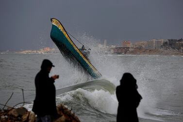 Palestinian fishermen ride their boat amid high waves on windy and rainy day at the sea in Gaza City, Sunday, Feb. 9, 2020. (AP Photo/Hatem Moussa)