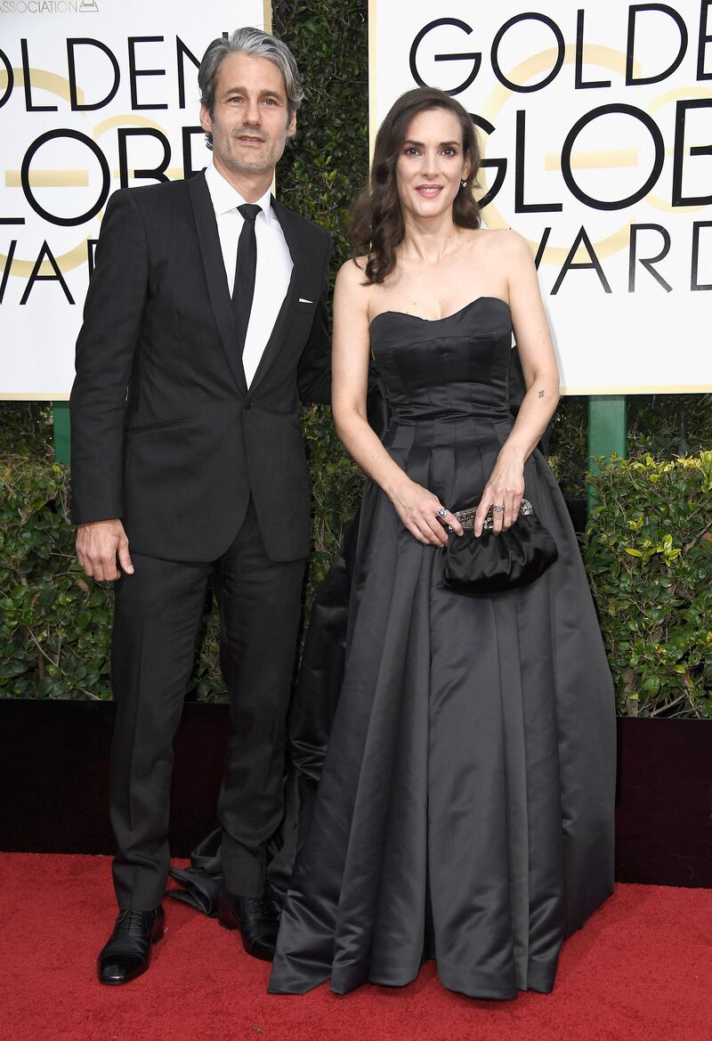 Winona Ryder, accompanied by fashion designer Scott Mackinlay Hahn, wears a custom Viktor & Rolf gown to the 74th Annual Golden Globe Awards at The Beverly Hilton Hotel on January 8, 2017. Getty