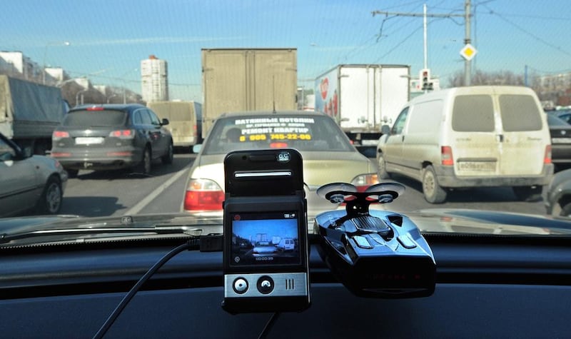 A mini camera with a screen placed on the dashboard of a car in a Moscow street. While dashcams are considered digital guardian angels of the Russian motorists, their use is in a grey area of the law in many countries, including the UAE. Yuri Kadobnov /  AFP