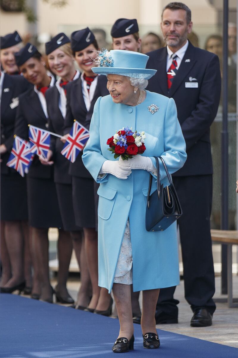 Queen Elizabeth II, in light blue, during a visit to the headquarters of British Airways at Heathrow, London, on May 23, 2019. Getty Images