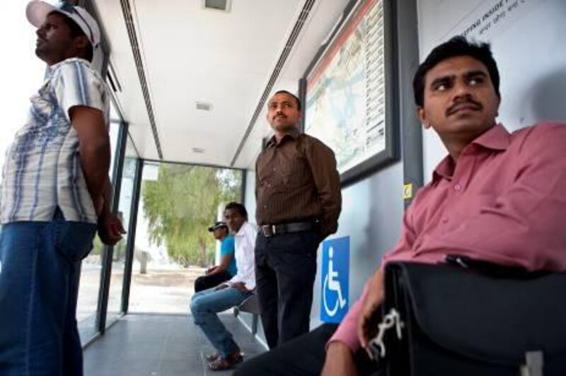 Nezar Veleri, an assistant pharmacist at the al Noor Hospital in Abu Dhabi, waits for his bus on Wednesday, July 27, 2011, during his daily commute to work that starts at an airconditioned bus stop near the Al Ain University in Abu Dhabi. Veleri swore off driving after a motorcycle accident in his native India a couple of years ago left him with broken bones and solid fear of driving.  (Silvia Razgova/The National)

