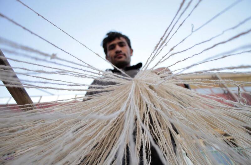 An man works at a carpet factory in Kabul. Afghanistan’s hand-woven rugs require skilled labour and are in great demand all over the world. Hedayatullah Amid / EPA