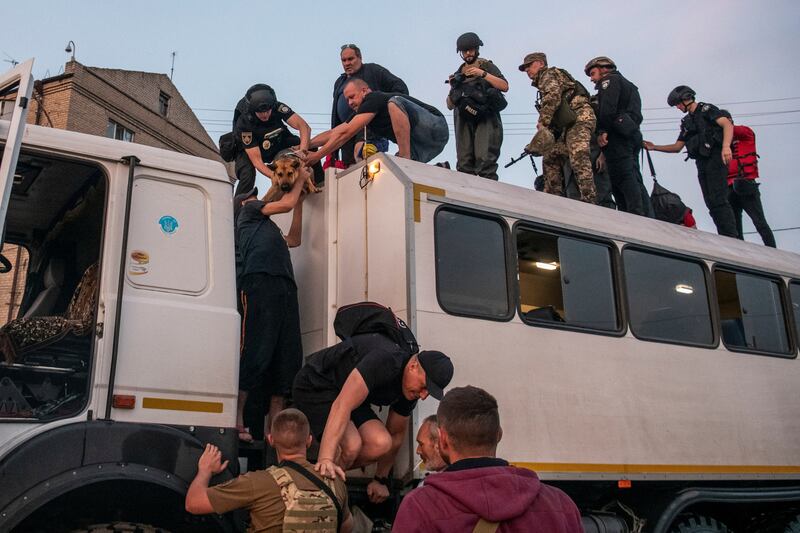 Residents are evacuated from a flooded area after the dam wall was breached during Russia's attack on Ukraine. Reuters