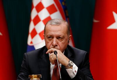 Turkey's President Recep Tayyip Erdogan talks during a joint news conference with Croatia's President Kolinda Grabar-Kitarovic, following their meeting at the Presidential Palace in Ankara, Turkey, Wednesday, Jan. 16, 2019. Erdogan said that an explosion that killed U.S. service members, during a routine patrol in the northern Syrian town of Manbij, may have been an act aimed to deter the United States from withdrawing troops. (AP Photo/Burhan Ozbilici)