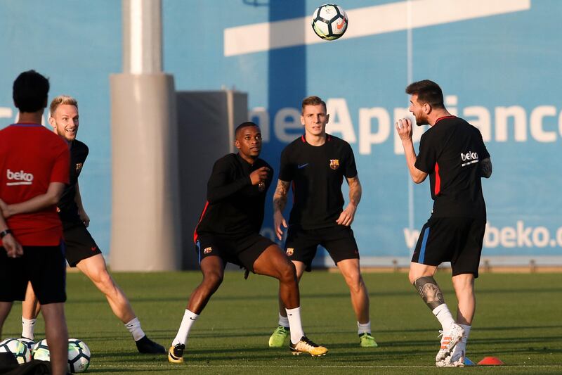 Lionel Messi, right, takes part in a training session with his Barcelona teammates. Pau Barrena / AFP