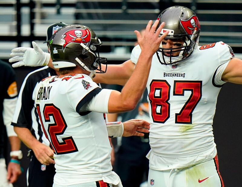 Tampa Bay Buccaneers tight end Rob Gronkowski celebrates with Tom Brady after scoring a touchdown against the Las Vegas Raiders in October 2020. AP