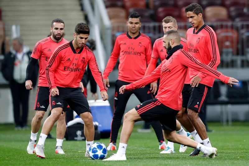 Marco Asensio, second from left, Karim Benzema, second from right, and Raphael Varane, right, attend a training session. AP Photo