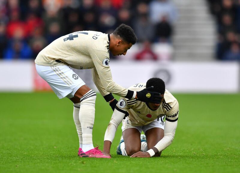 Manchester United's Jesse Lingard helps Marcus Rashford to his feet. Reuters