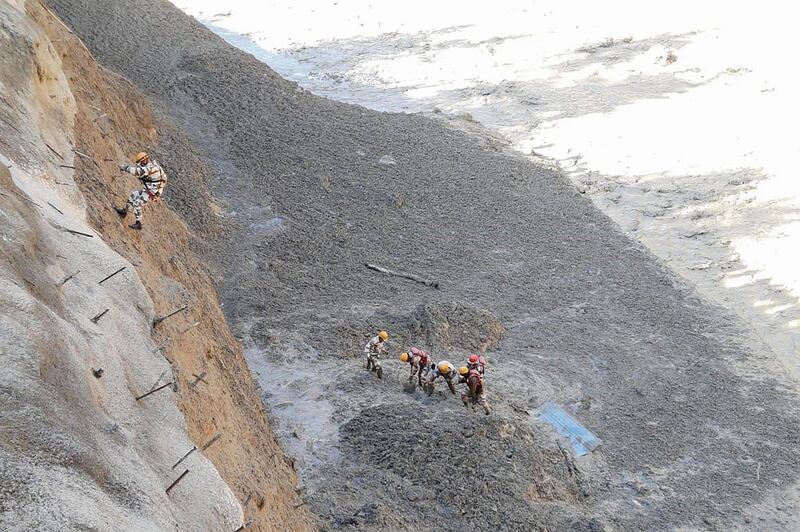 This handout photograph provided by the Indo-Tibetan Border Police shows police personnel during a rescue operation to clear debris from Tapovan tunnel following floods after a glacier collapsed in the Chamoli district. Part of a Himalayan glacier broke away into an Indian river, causing huge torrents that breached a dam and swept away bridges and roads. AFP