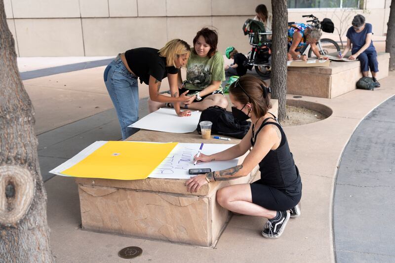 Demonstrators make signs at a rally in Tucson. Reuters