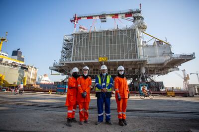 Petrofac grads and country chair on site. Photo: Petrofac