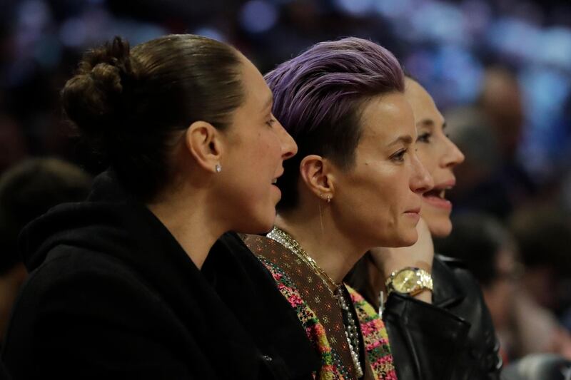 US Women's soccer players Diana Taurasi, Megan Papinoe and Sue Bird watch the action.  AP