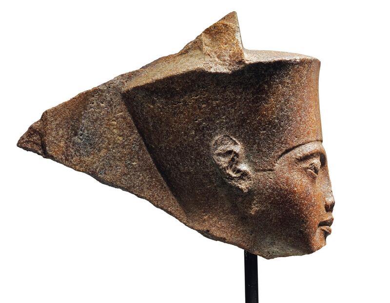 This image released by Christie's on Tuesday, June 11, 2019, shows a 3,000-year-old stone sculpture of the famed boy pharaoh Tutankhamun at Christie's in London. Egypt is trying to halt the auction of the sculpture of Tutankhamun at Christie's in London. The Foreign Ministry issued a statement late on Monday saying Egyptian authorities demand the auction house provide documents proving the artifact's ownership. (Christie's via AP)