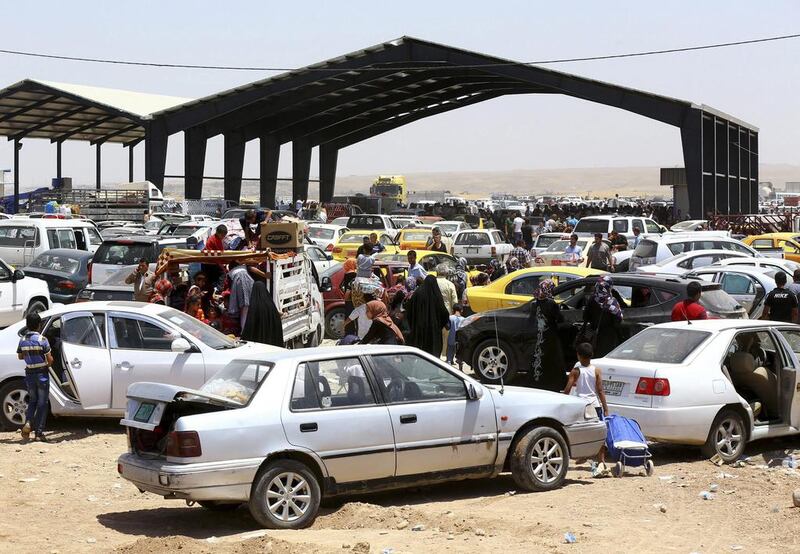 Thousands of families fleeing from Mosul, one of the great historic cities of the Middle East, arrive at a checkpoint in outskirts of Arbil on June 10, 2014. Reuters