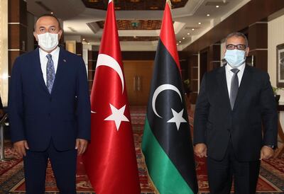 Turkey's Foreign Minister Mevlut Cavusoglu, left, and Khalid Al-Mishri, Head of the Libyan High Council of State, pose for a photo before their talks, in Tripoli, Libya, Thursday, Aug. 6, 2020. (Fatih Aktas/Turkish Foreign Ministry via AP, Pool)