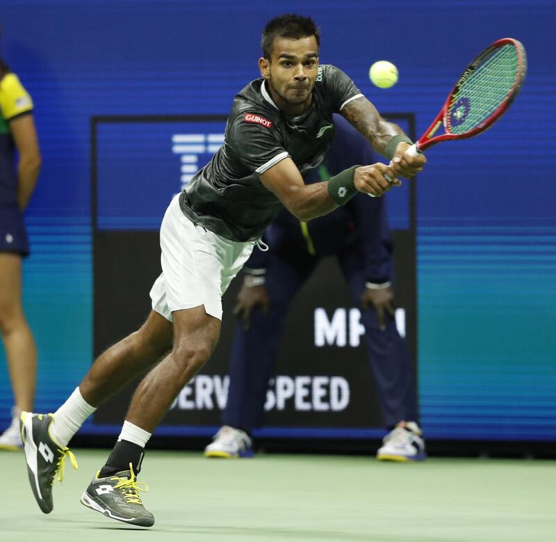 Sumit Nagal of India hits a return to Roger Federer. EPA