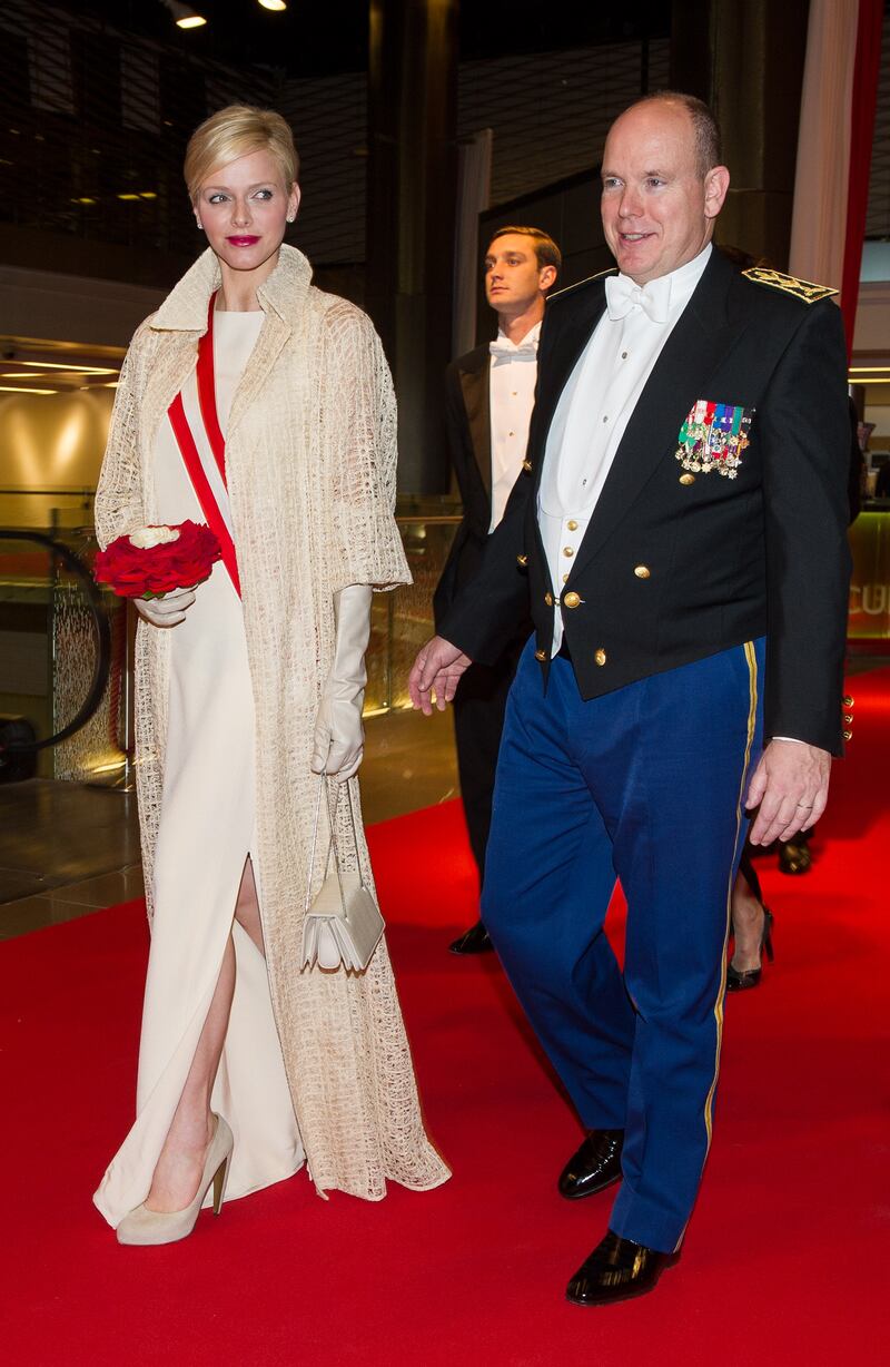 Princess Charlene, in a cream dress and cardigan, and Prince Albert II of Monaco attend the Monaco National Day Gala Concert on November 19, 2012. Getty Images