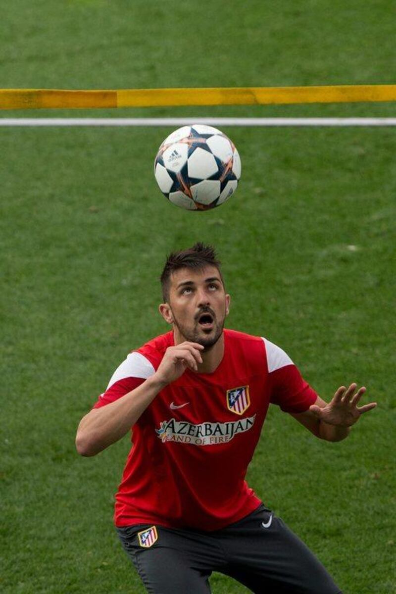 David Villa of Atletico Madrid head the ball during Monday's training session ahead of the Champions League final. Gonzalo Arroyo Moreno / Getty Images / May 19, 2014