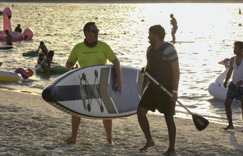 Abu Dhabi, United Arab Emirates - People enjoying various water sport activities at Club Social Festival on Yas Beach. Khushnum Bhandari for The National
