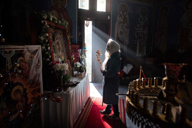 Worshippers pray to an icon as they depart following a service of the Nativity of Christ Liturgy in the Serbian Orthodox Church of the Holy Prince Lazar in Bournville, Birmingham, central England. Orthodox Christians celebrate Christmas according to the Julian calendar where Christmas Day falls on January 7. The Lazarica church, dedicated to the Holy Prince Lazar, is the first purpose-built Serbian Orthodox church constructed in the UK and is decorated in a 14th Century Byzantine-Morava artistic style.  AFP