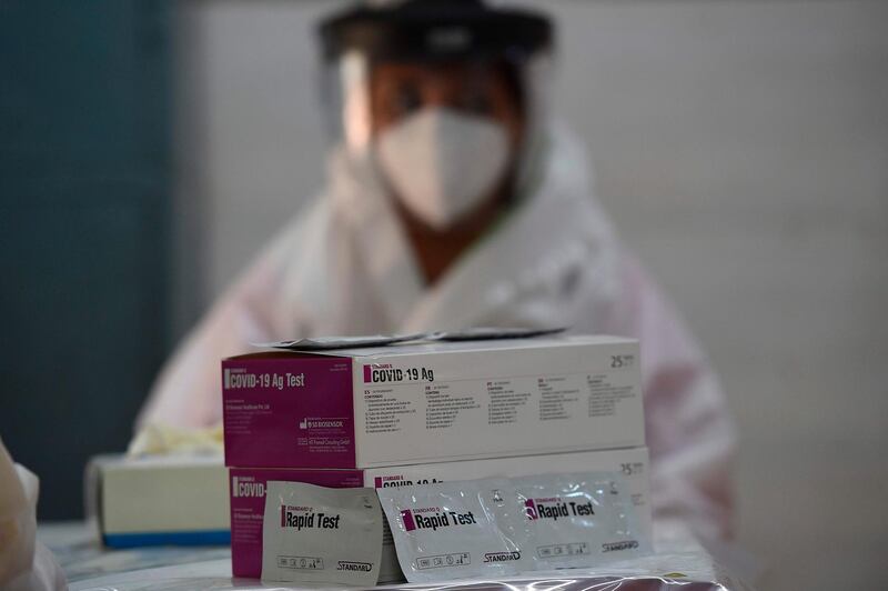 A medical worker waits for people to be tested with rapid antigen test (RAT) for the Covid-19 coronavirus in New Delhi. AFP