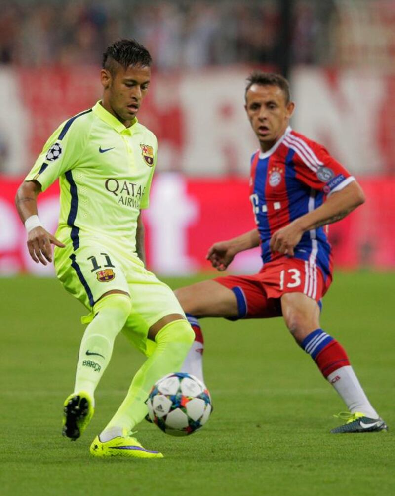 Neymar of Barcelona is watched by Rafinha of Bayern Muenchen during the UEFA Champions League semi final second leg match between FC Bayern Muenchen and FC Barcelona at Allianz Arena on May 12, 2015 in Munich, Germany.  (Photo by Adam Pretty/Bongarts/Getty Images)