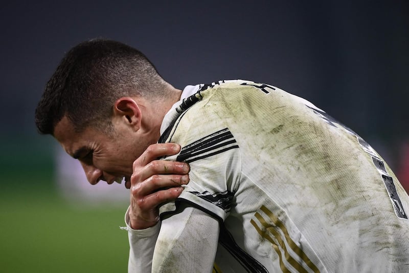 Ronaldo holds his shoulder after being tackled. AFP