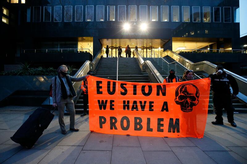 Protesters hold up a banner reading 'Euston, We Have A Problem'. Getty Images