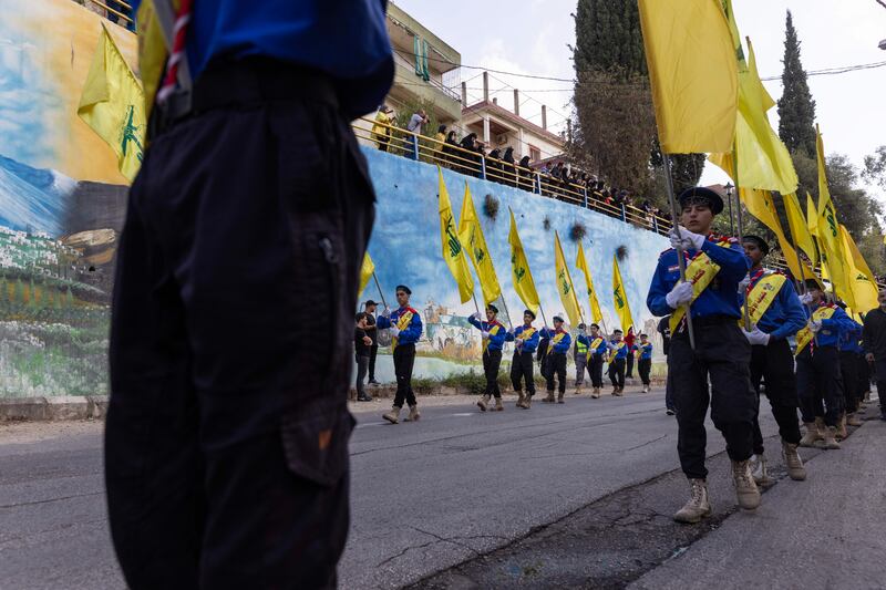 Scouts carry Hezbollah flags at a funeral for two Hezbollah soldiers killed in South Lebanon. Getty Images