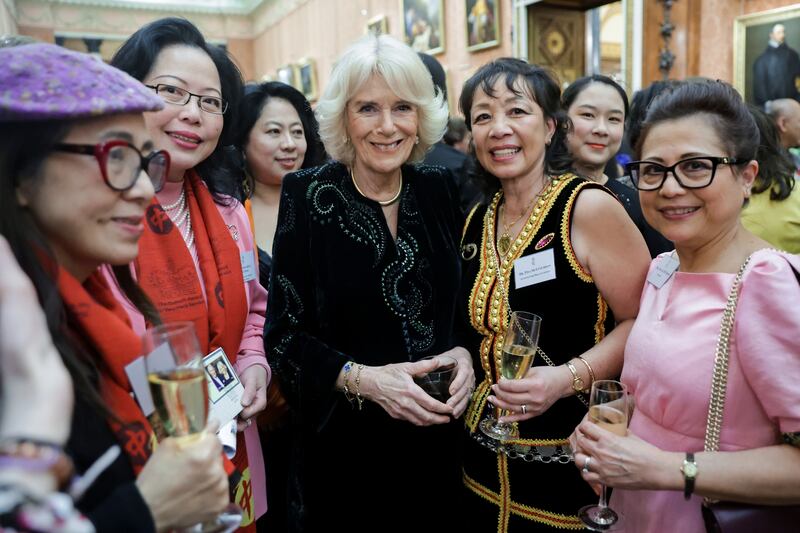 Queen Consort Camilla with women from Britain's East and South-East Asian communities at Buckingham Palace. PA