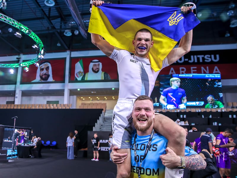 Yevhenii Kabanets of Ukraine celebrates with his coach.