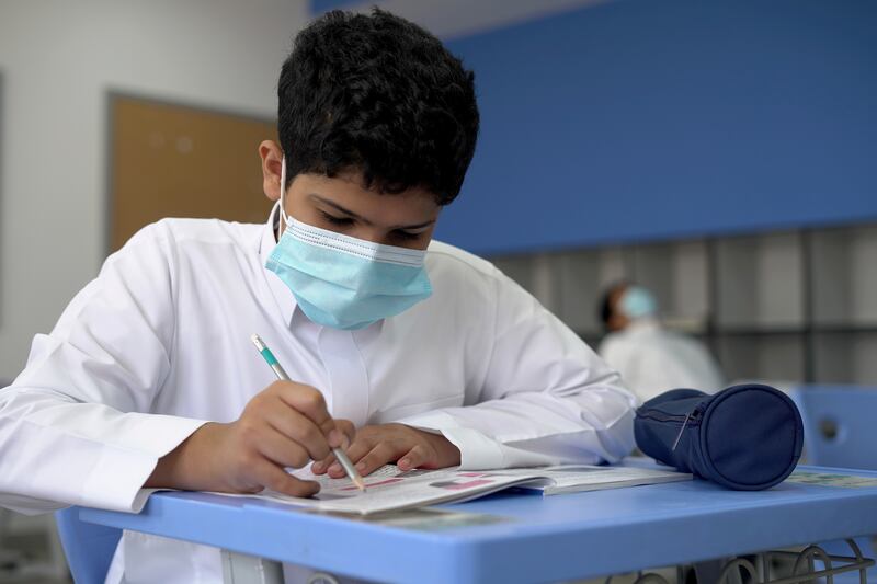 A Saudi schoolboy wearing a face mask in a classroom in Riyadh. Reuters