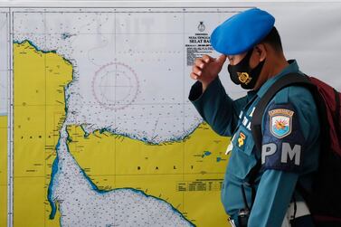 epa09154069 A military officer stands in front of a map of the search area for the missing Indonesian Navy submarine KRI Nanggala, at a command in Ngurah Rai Airport in Bali, Indonesia, 23 April 2021. The German-made submarine was reported missing on 21 April 2021 near the island of Bali with 53 people on board while preparing to conduct a torpedo drill, the the Indonesian National Armed Forces said. EPA/MADE NAGI