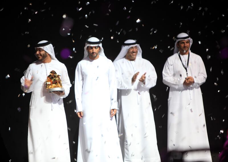 DUBAI - UNITED ARAB EMIRATES - 18MAR2013 -  Sheikh Hamdan bin Mohammed bin Rashid al Maktoum, Crown Prince of Dubai presents the grand prize trophy to Osama al Zubeidi (L) of UAE in Beauty of Lights catgory in Hamdan International Photography Awards yesterday in Dubai.  Ravindranath K / The National 