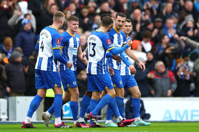 Brighton's Lewis Dunk celebrates with teammates after levelling the scores at 1-1. Getty