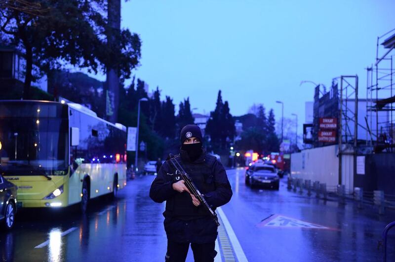 A Turkish police officer stands guard near the Reina night club. Yasin Akgul / AFP Photo