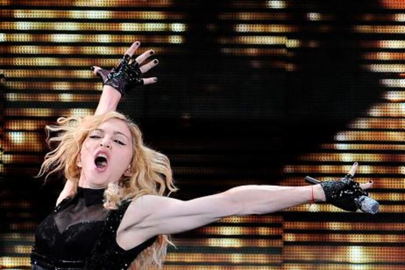 YEARENDER 2009<br />US singer Madonna performs during her "Sticky & Sweet Tour" concert on July 23, 2009 at the Vicente Calderon stadium in Madrid.    AFP PHOTO / DANI POZO *** Local Caption ***  380104-01-08.jpg