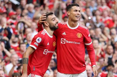MANCHESTER, ENGLAND - SEPTEMBER 11: Bruno Fernandes of Manchester United celebrates with Cristiano Ronaldo after scoring their side's third goal during the Premier League match between Manchester United and Newcastle United at Old Trafford on September 11, 2021 in Manchester, England. (Photo by Clive Brunskill / Getty Images)