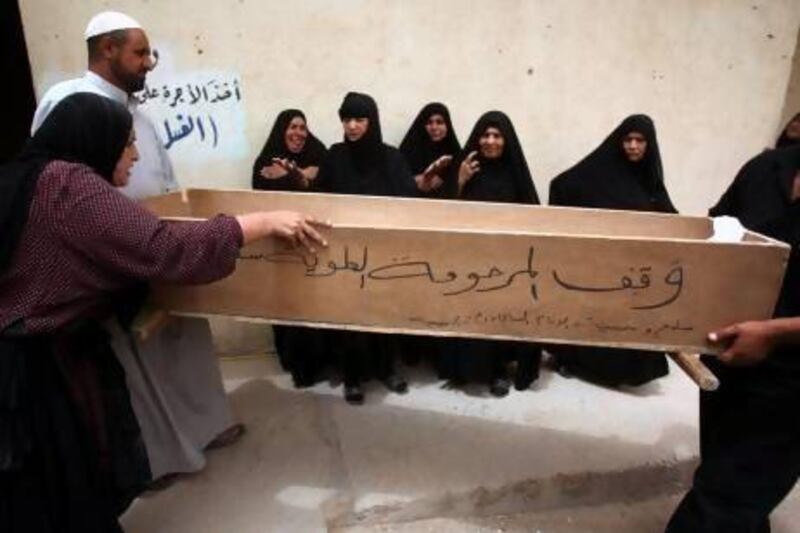 Mourners at the funeral of a relative in Najaf, Iraq. The relative was killed by an explosion in a Basra market in 2010. Alaa Al-Marjani / AP Photo