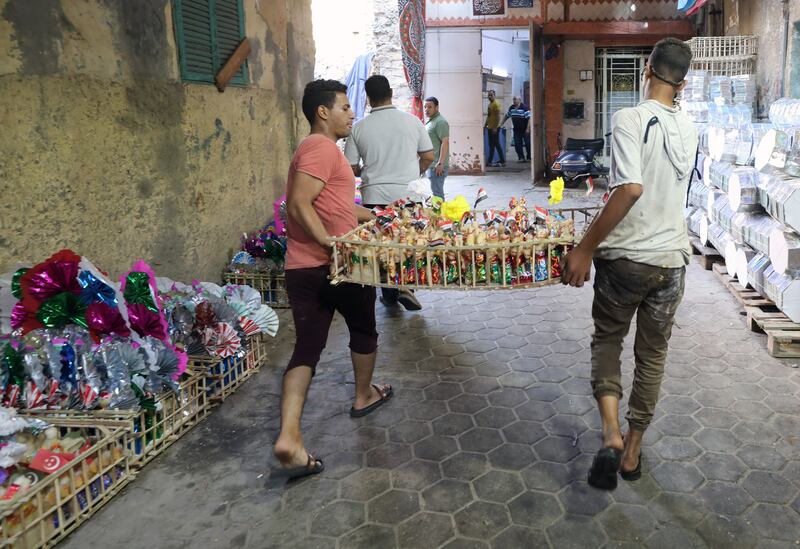 Egyptian workers carry a crate with decorated candy figures in preparation for Mawlid, marking the birthday of the Prophet Mohammed, in the Al Khalifa district of Cairo. EPA