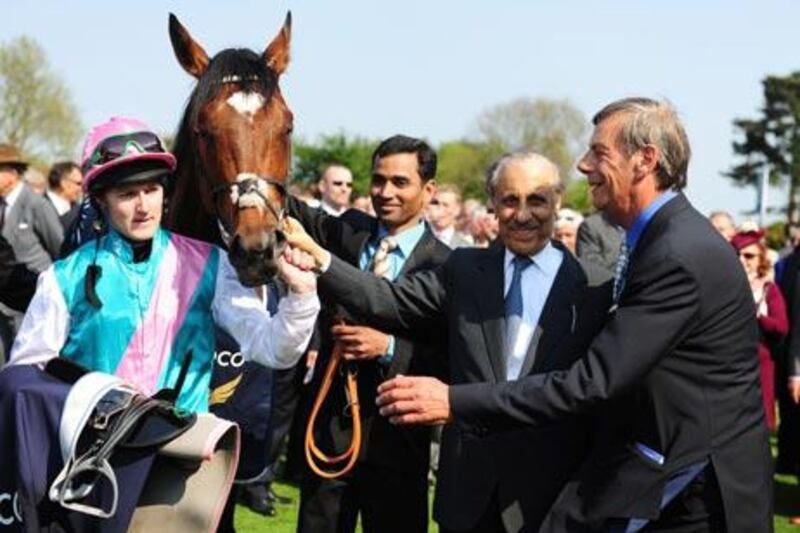 Tom Queally, the jockey, and Frankel are joined by the owner, Prince Khalid Abdullah, of Saudi Arabia, second right, and the trainer Sir Henry Cecil, after winning the Qipco 2000 Guineas Stakes at Newmarket Racecourse.