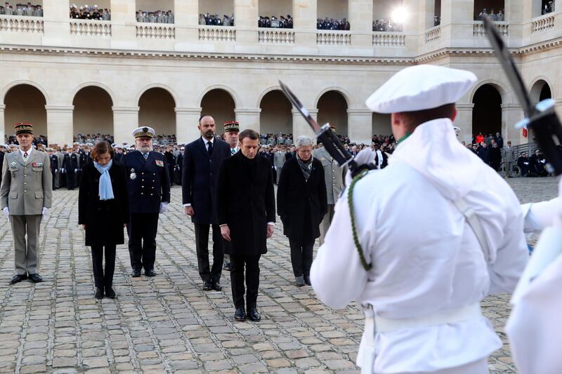 French President Emmanuel Macron with French defence minister Florence Parly review the troops during the national ceremony.  EPA