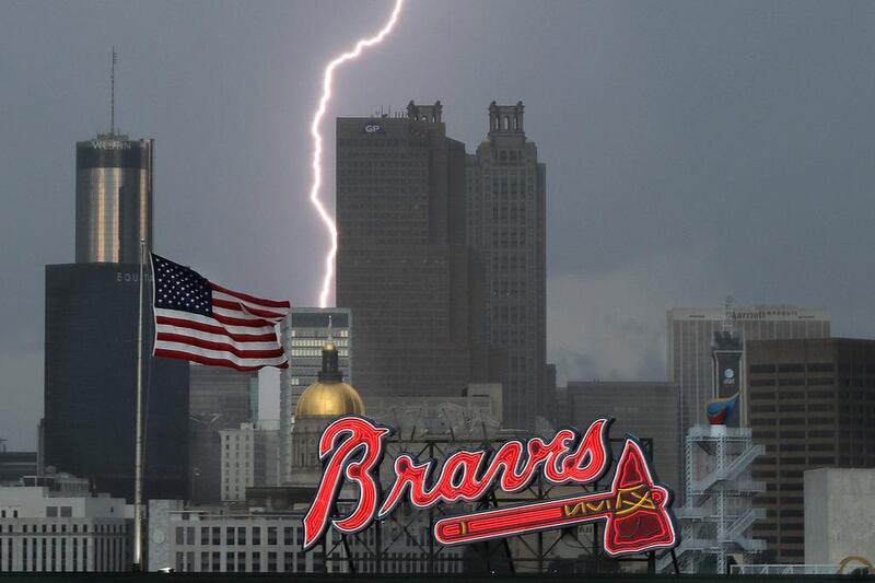 A lightning storm moves through Atlanta before the Atlanta Braves play the Washington Nationals in a baseball game. Curtis Compton / Atlanta Journal-Constitution via AP Photo